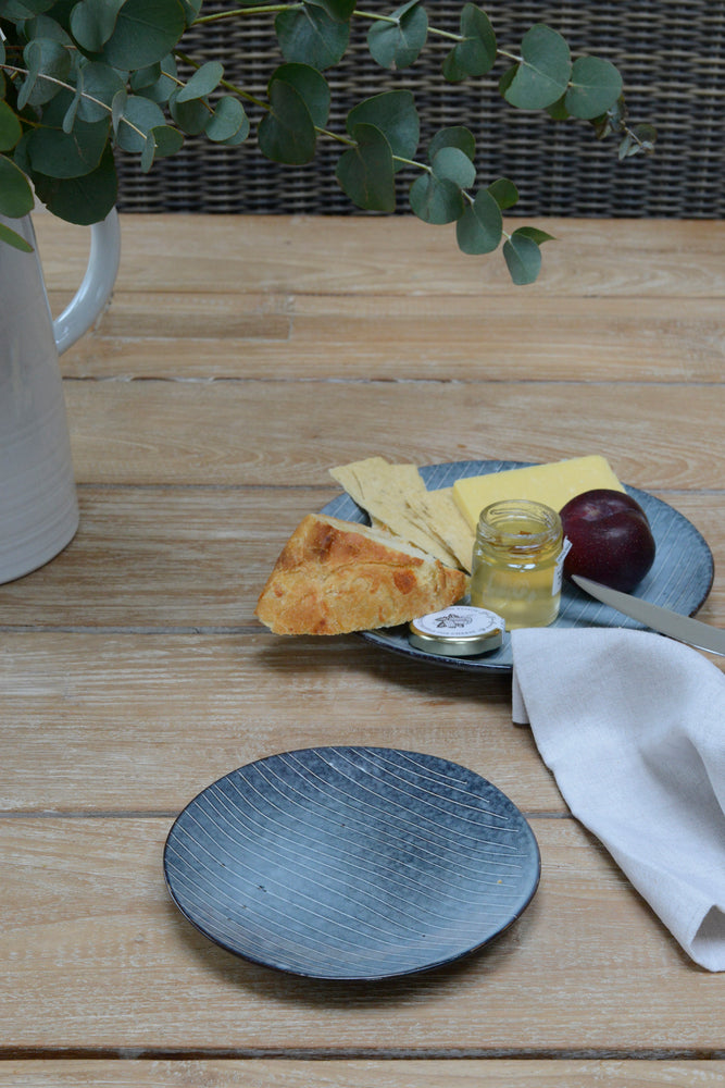 Nordic sea side plate in lifestyle shot next to cheese plate