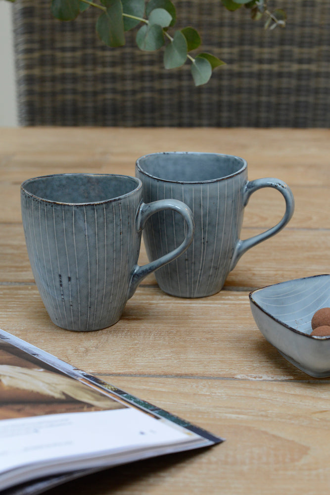 Two Blue nordic sea handled mugs stood next to eachother
