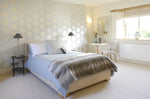 A bedroom interior with pale colours