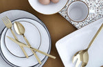 Plates, bowls and cutlery on a dining table. 