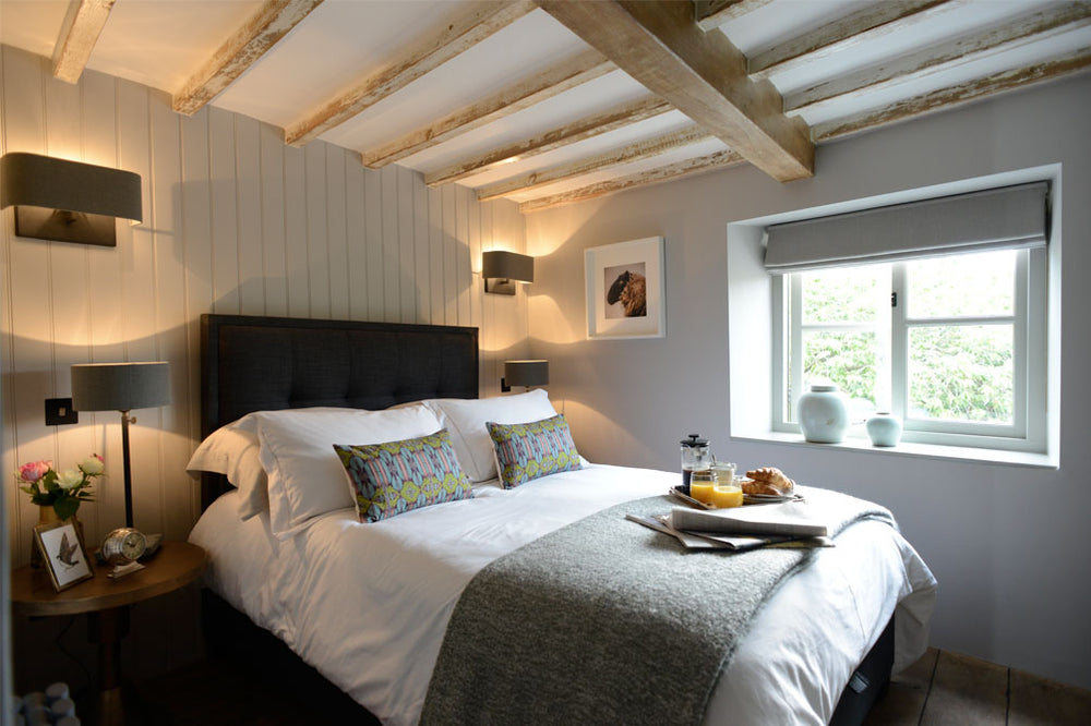 A traditional bedroom interior with wooden walls and roof by Cotswold Grey