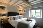 A traditional bedroom interior with wooden walls and roof by Cotswold Grey