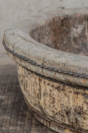 Close up of the aged wooden body of the shallow tea pickers bowl.