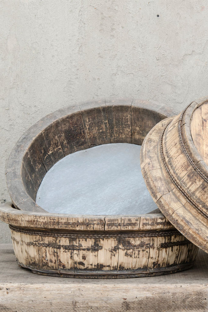 A set of tin based shallow tea pickers bowl with wooden rim.