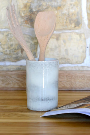 Utensil pot on kitchen counter.