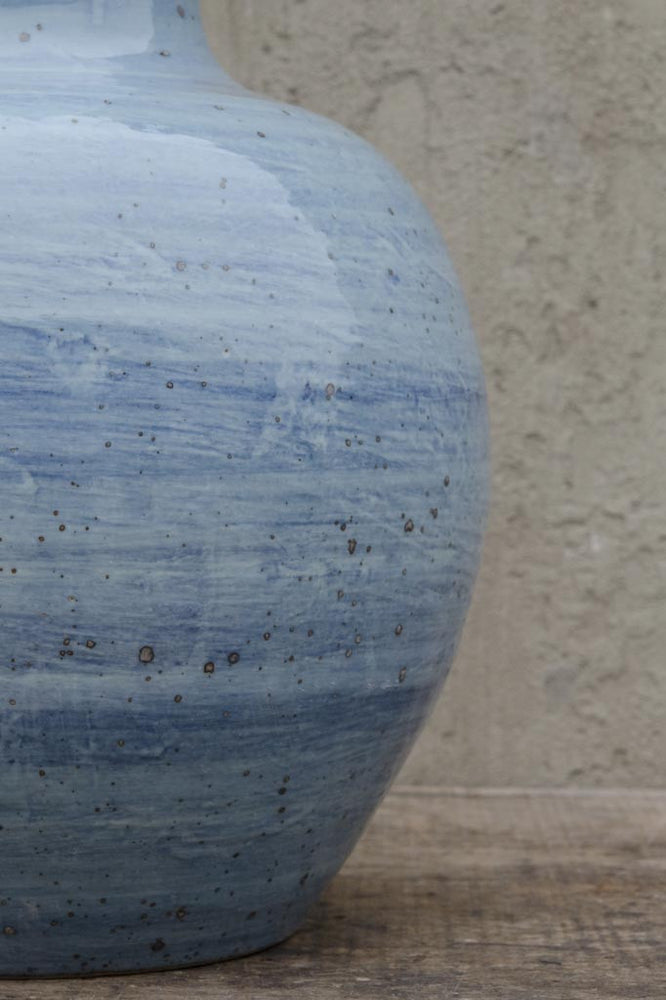 A close up of Van Thiel's long neck blue swirl vase