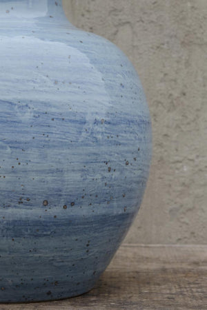 A close up of Van Thiel's long neck blue swirl vase